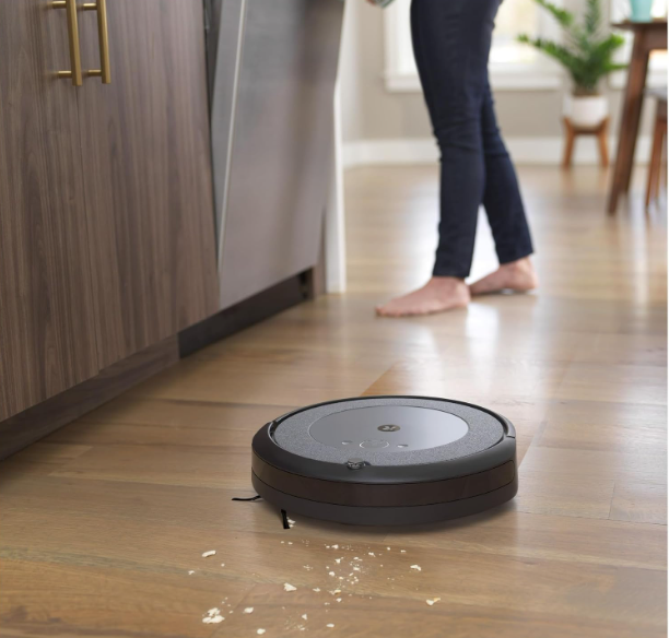 iRobot® Roomba Combo™ i5 Robot Vacuum and Mop cleaning a hardwood floor, showcasing its dual functionality of vacuuming and mopping simultaneously